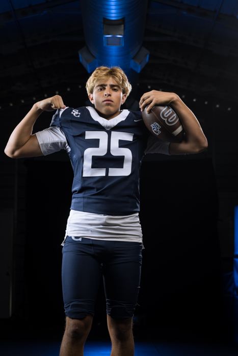 Davide Morales flexing with the football on his shoulder