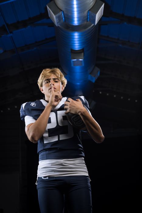 Davide Morales holding the football with a finger to his lips