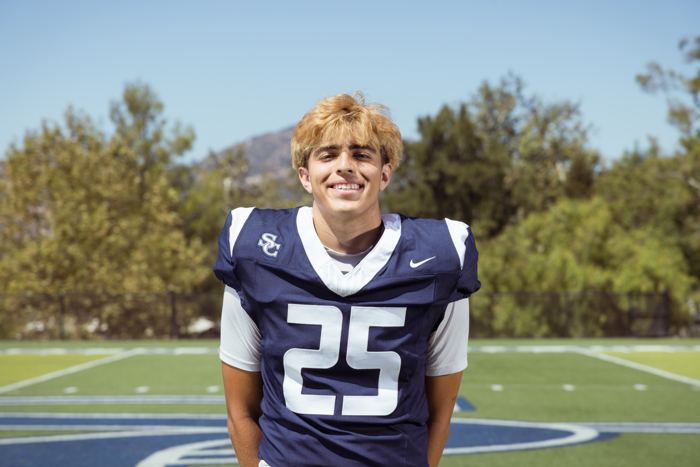 Davide Morales smiling in his #25 jersey on the Sierra Canyon field