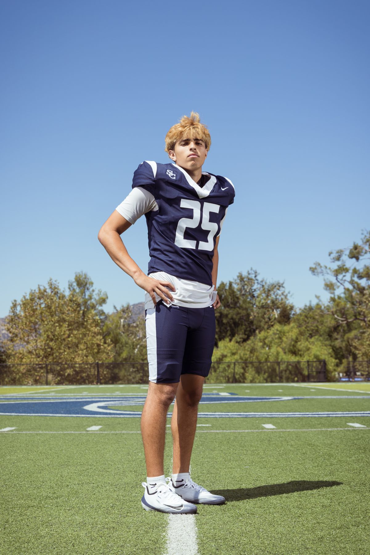 Davide Morales in his navy Sierra Canyon #25 uniform standing on the field